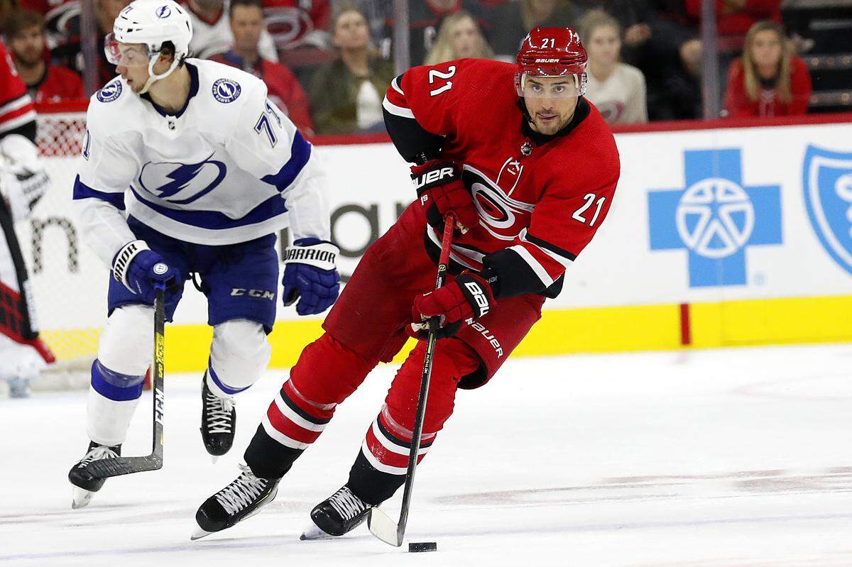 Carolina Hurricanes’ Nino Niederreiter (21) moves the puck against the Tampa Bay Lightning during the second period of an NHL hockey game, in Raleigh, N.C., Sunday, Oct. 6, 2019. (AP Photo/Karl B DeBlaker)