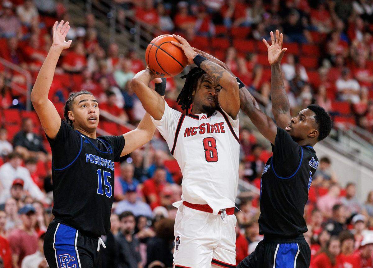 N.C. State’s Jayden Taylor is pressured by Presbyterian’s Jonah Pierce and Kory Mincy during the second half of the Wolfpack’s 81-72 win on Friday, Nov. 8, 2024, at Lenovo Center in Raleigh, N.C.
