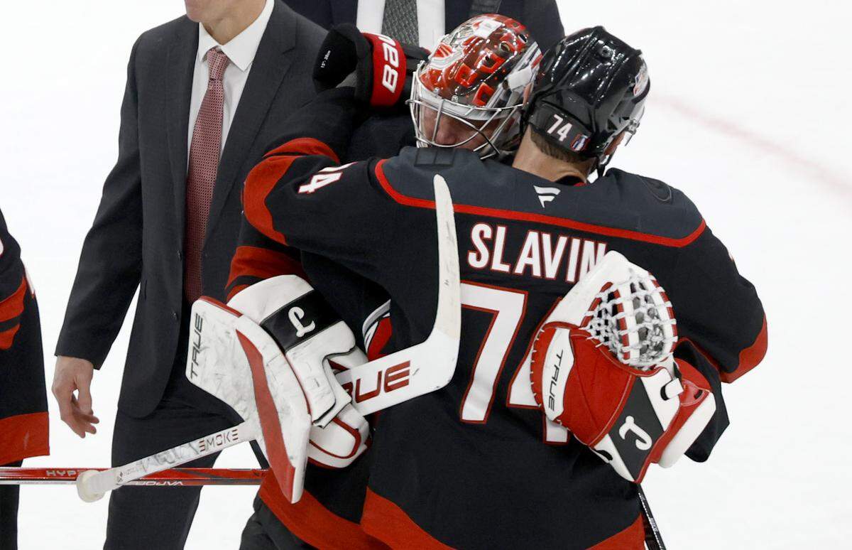 Carolina's Jaccob Slavin (74) and Frederik Andersen (31) hug after the Hurricanes’ 6-1 victory over the Canadiens in game five of the Eastern Conference Finals at the Lenovo Center Friday, May 29, 2026.