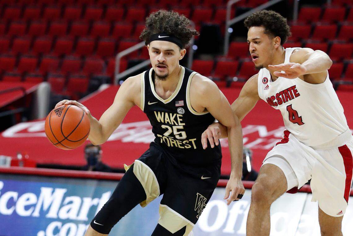 Wake Forest’s Ismael Massoud (25) drives by N.C. State’s Jericole Hellems (4) during the first half of N.C. State’s game against Wake Forest at PNC Arena in Raleigh, N.C., Wednesday, January 27, 2021.