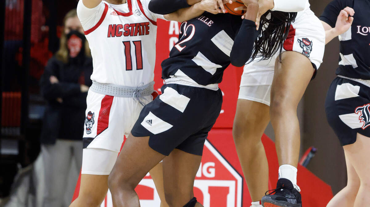 N.C. State’s Camille Hobby (41), right and Jakia Brown-Turner (11) battle Louisville’s Liz Dixon (22) for the rebound during the first half of N.C. State’s game against Louisville at Reynolds Coliseum in Raleigh, N.C., Thursday, Jan. 20, 2022.