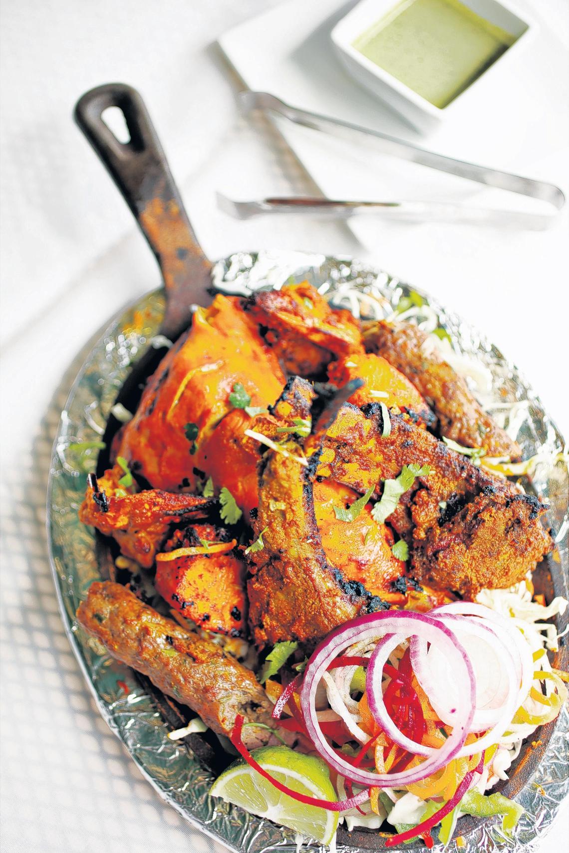 The Bawarchi Mixed Grill is a platter served with chicken tikka, tandoori chicken, lamb chop, seekh kabab and shrimp tikka at Bawarchi Grill & Spirits in Apex.