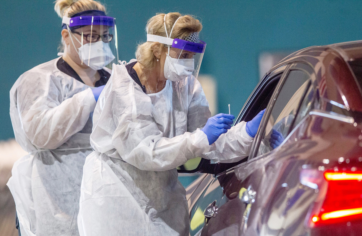Caroline Barrett, LPN, left, and Teresa Holland, FNP, of Goshen Medical Center, perform coronavirus tests at the Duplin County Events center in Kenansville Wednesday, May 20, 2020.