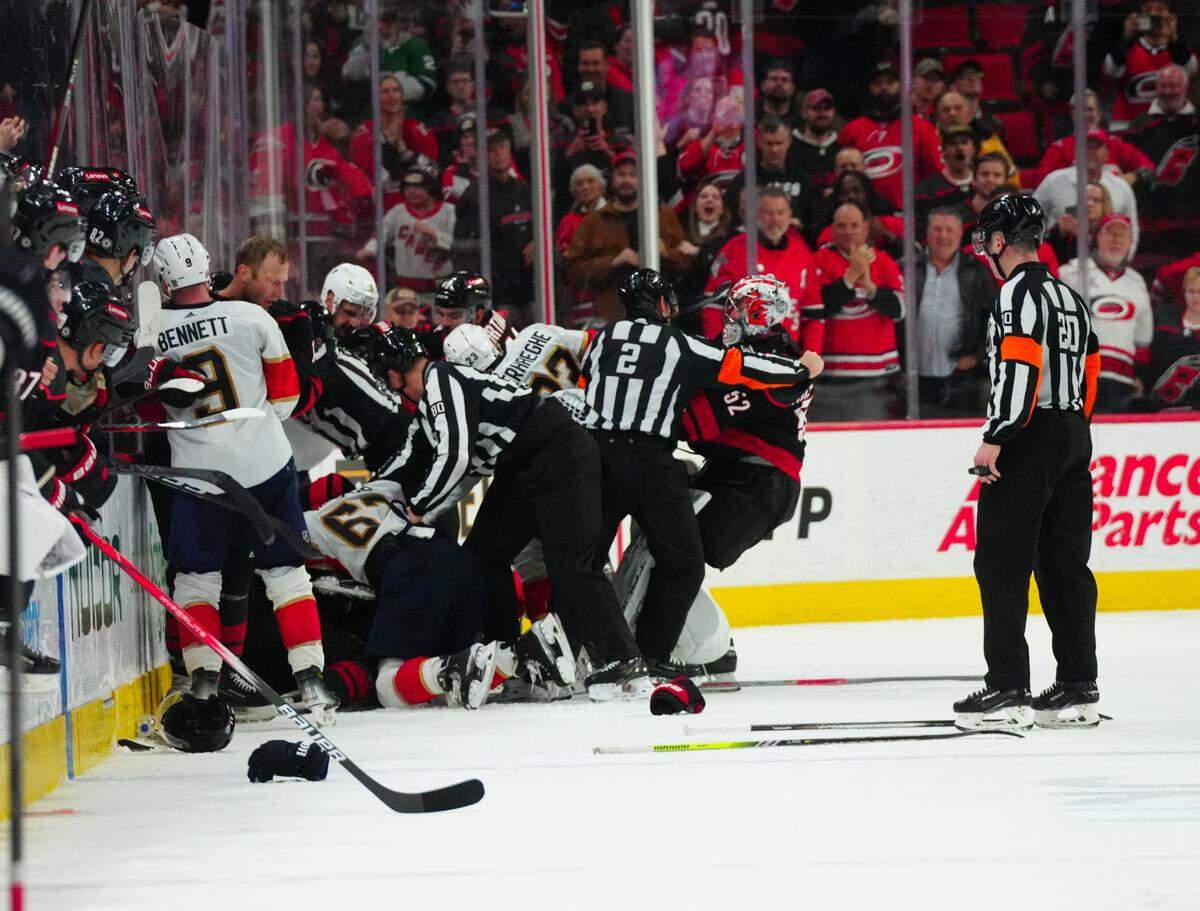 Feb 22, 2024; Raleigh, North Carolina, USA; Carolina Hurricanes players and Florida Panthers players battle in the 3rd period at PNC Arena. Mandatory Credit: James Guillory-USA TODAY Sports