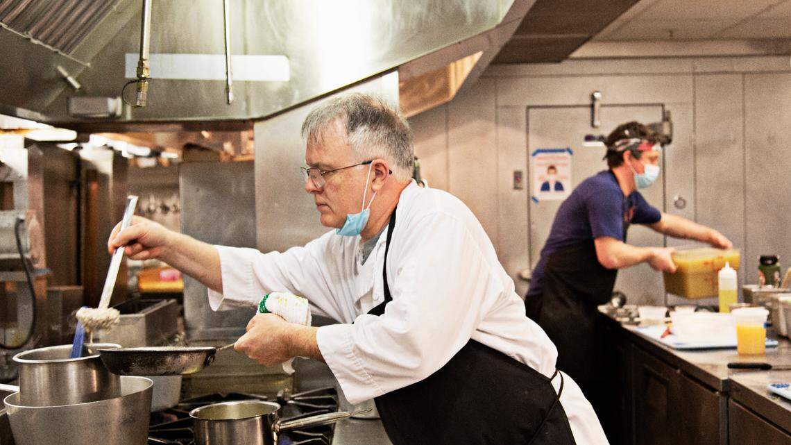 Chef Shane Ingram ladles grits into a pan in the kitchen at The Durham on Thursday, Feb. 24, 2022.