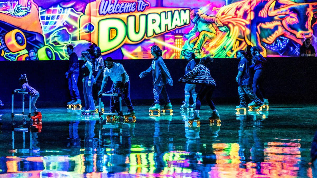 Roller-skaters circle the rink of Wheels Durham roller-skating rink on Hoover Road Friday, Feb. 28, 2025 after having been closed in 2020 after four decades. In 2021, the city bought the space and began renovations after residents demanded the return of the safe space for youth in East Durham.