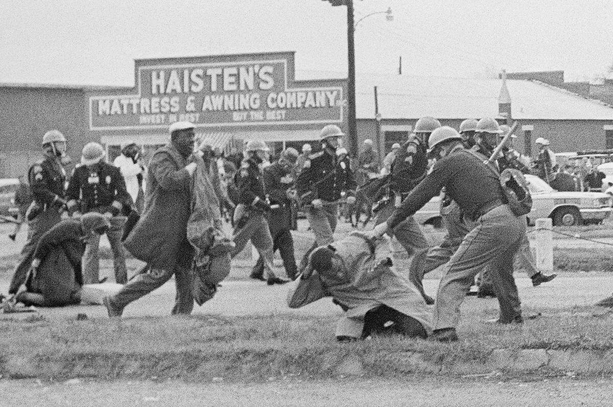 In this March 7, 1965, file photo, a state trooper swings a billy club at John Lewis, right foreground, chairman of the Student Nonviolent Coordinating Committee, to break up a civil rights voting march in Selma, Ala. Lewis sustained a fractured skull. Lewis, who carried the struggle against racial discrimination from Southern battlegrounds of the 1960s to the halls of Congress, died Friday, July 17, 2020.