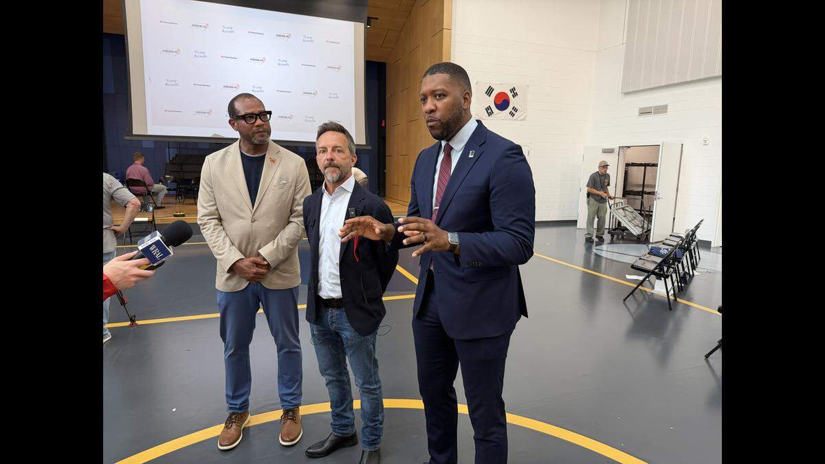 Mayor Leo Williams (right), Brad Gerstner of Invest America Foundation, and Mike Lee, the chair of the Durham County Commissioners, talk to media on May 22, 2026 about why the investment accounts are important for the area’s children.
