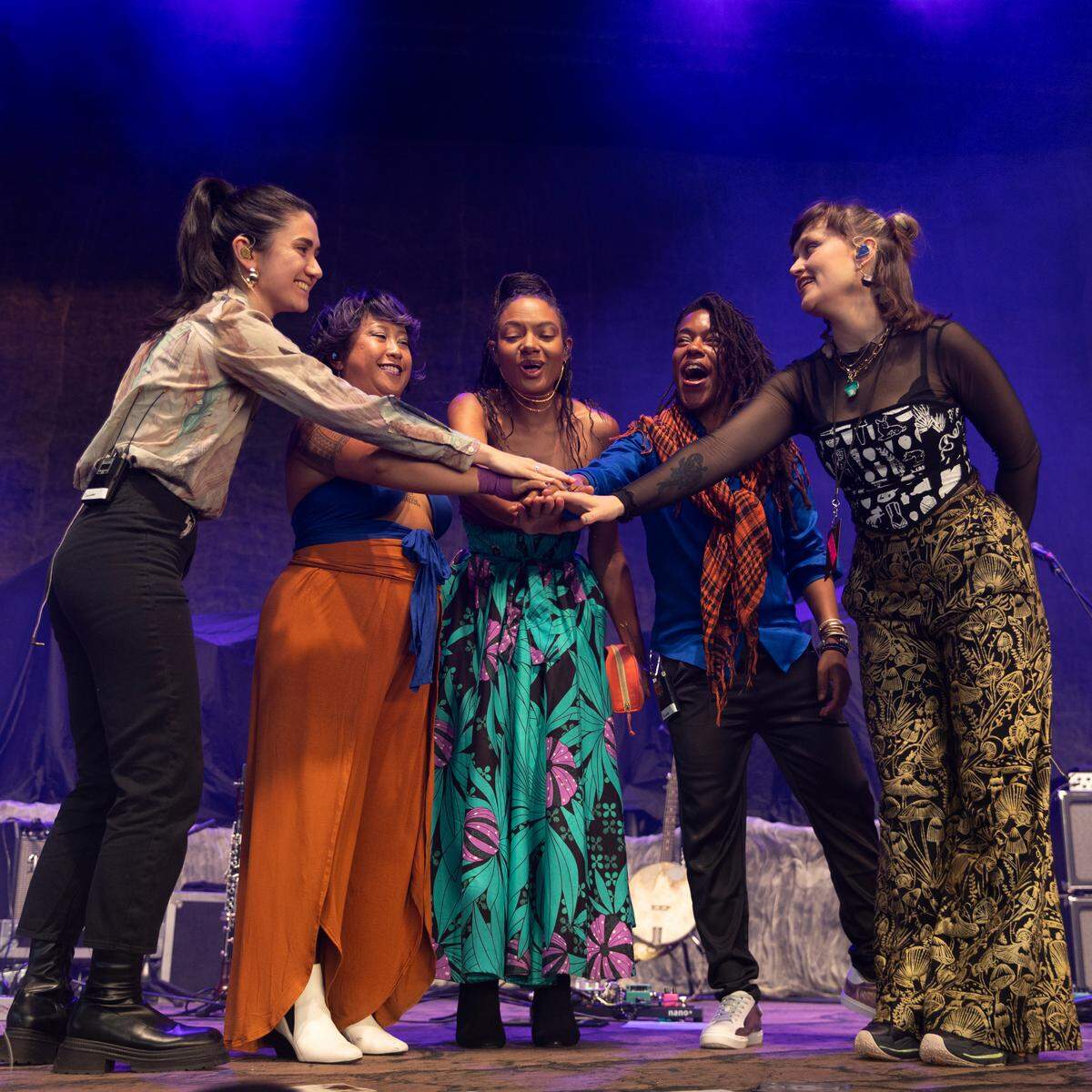 Allison Russell (center) and her band prepare to start their set opening for Hozier in concert at Coastal Credit Union Music Park at Walnut Creek in Raleigh, N.C., Saturday night, April 20, 2024.