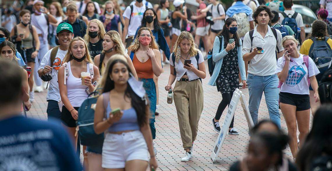 University of North Carolina students walk between the Student Union and Wilson Library on the first day of classes on Wednesday, August 18, 2021 in Chapel Hill, N.C. Thousands of students have returned to campus amid a surge in COVID-19 cases.