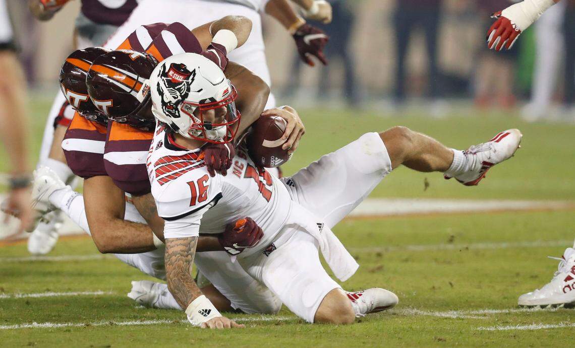 Virginia Tech linebacker Rayshard Ashby (23) sacks N.C. State quarterback Bailey Hockman (16) during the first half of N.C. State’s game against Virginia Tech at Lane Stadium in Blacksburg, VA Saturday, Sept. 26, 2020.