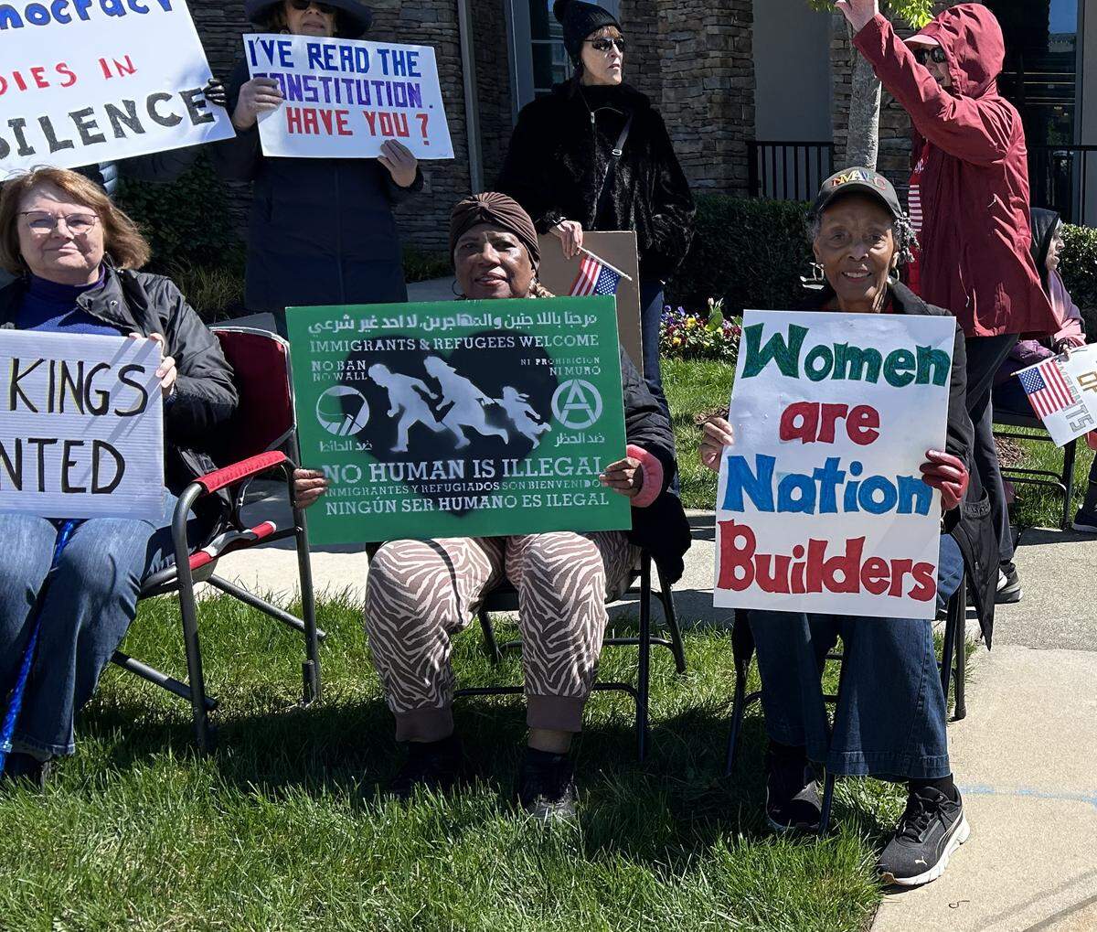 Joanne Smart Drane, at right, one of two students who integrated Women’s College of the University of North Carolina, now UNC-Greensboro, joins a No Kings rally outside her senior citizens apartments in North Raleigh Saturday.