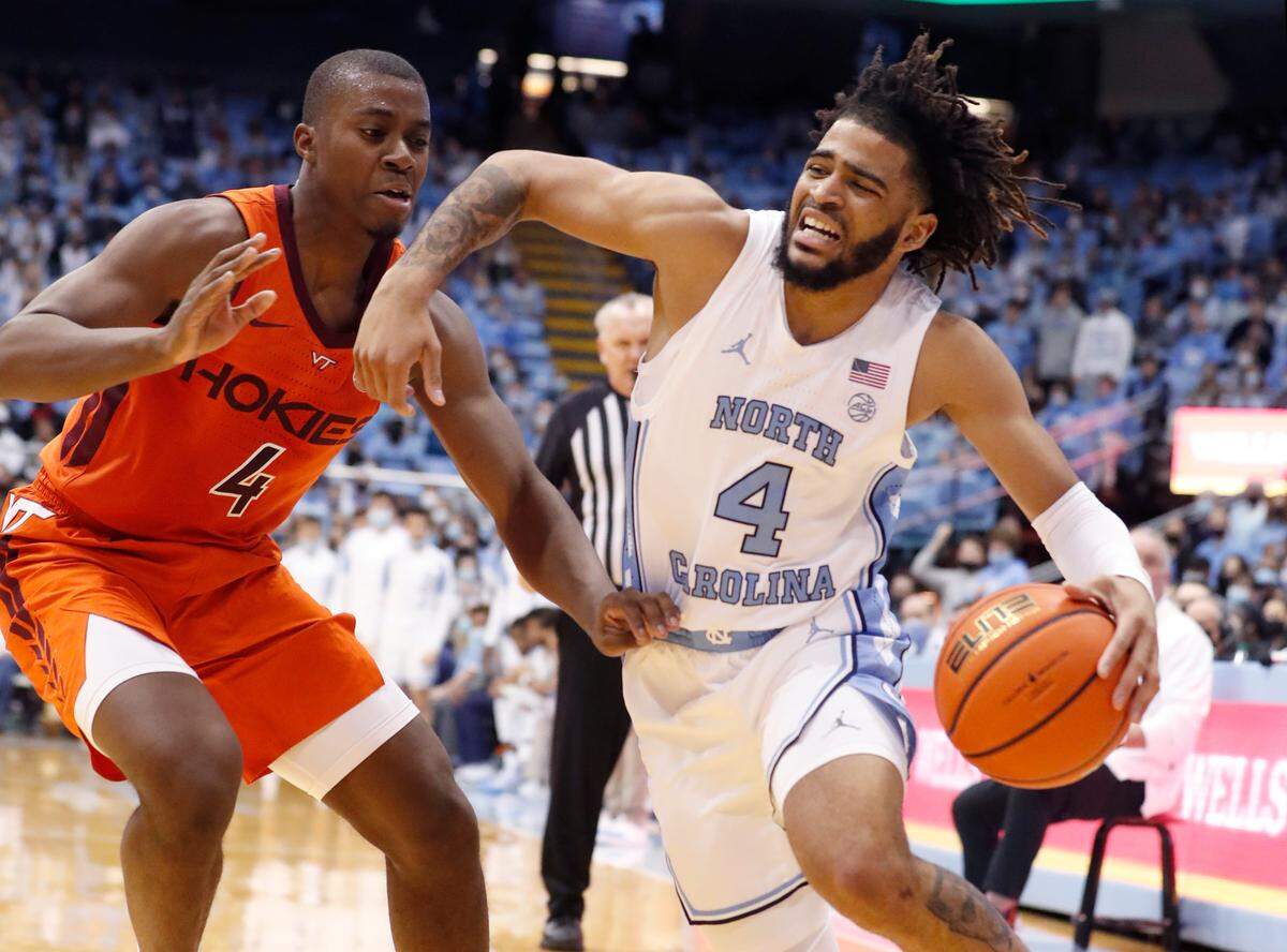 North Carolina’s RJ Davis (4) drives around Virginia Tech’s Nahiem Alleyne (4) during the first half of UNC’s game against Virginia Tech at the Smith Center in Chapel Hill, N.C., Monday, Jan. 24, 2022.