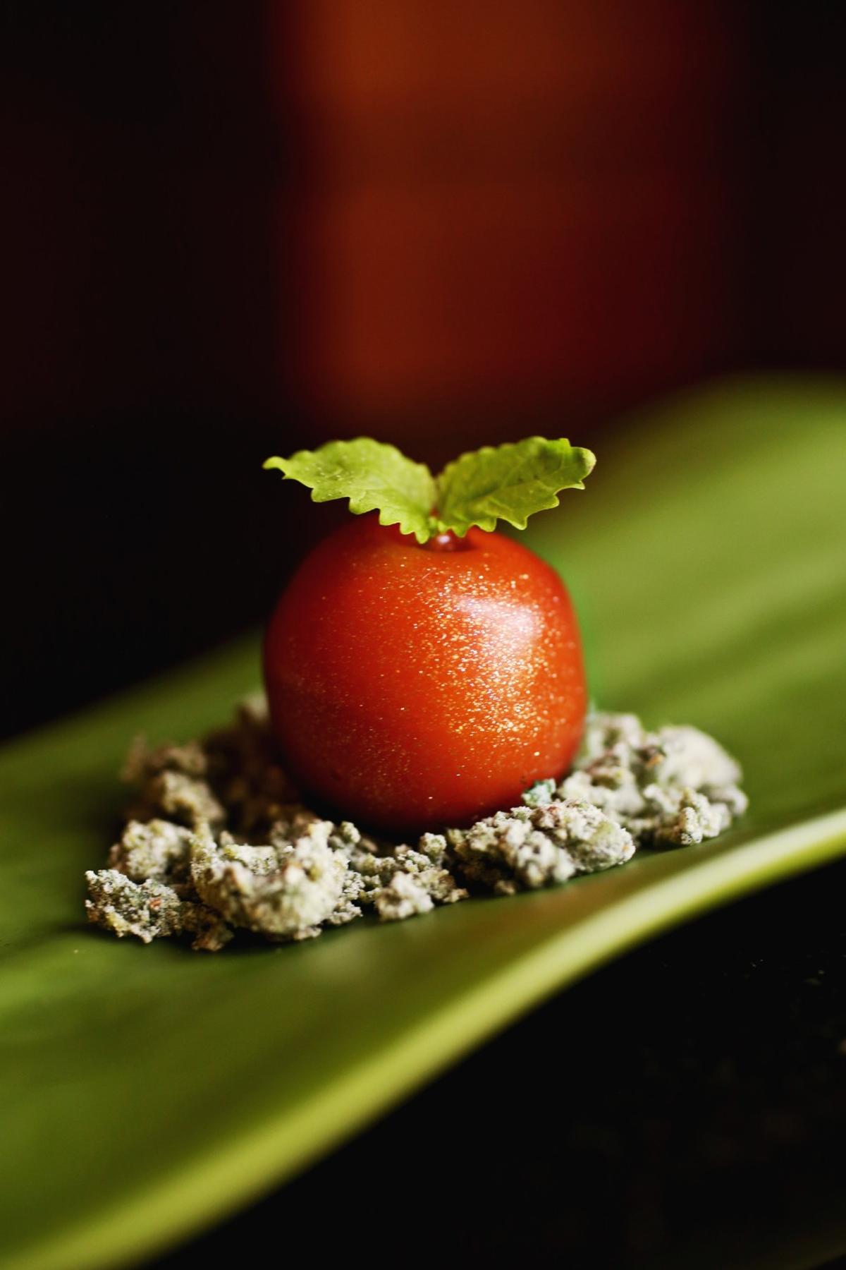 Spheres of semi-frozen gazpacho encased in a vermilion glaze are served with tiny shiso leaves atop a shiso-tinged tempura crunch as part of a series of amuses-bouches in Herons’ eight-course tasting menu called “The Art Tour.”
