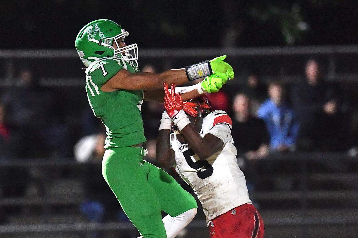 Middle Creek's Derrick Morton (5) makes the interception against Cary's Jaylin Spivey (7) during the first half. The Cary Imps and the Middle Creek Mustangs met in a conference football game in Cary, N.C. on October 24, 2025