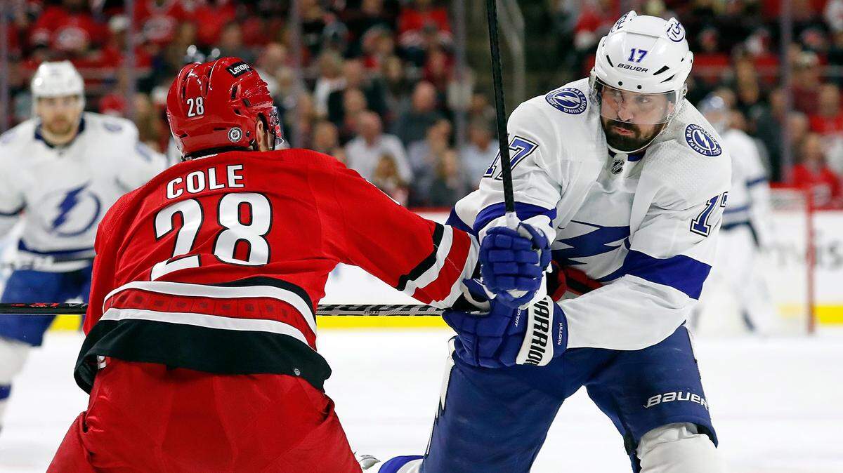 Carolina Hurricanes’ Ian Cole (28) tries to slow down Tampa Bay Lightning’s Alex Killorn (17) during the first period of an NHL hockey game in Raleigh, N.C., Tuesday, March 22, 2022. (AP Photo/Karl B DeBlaker)