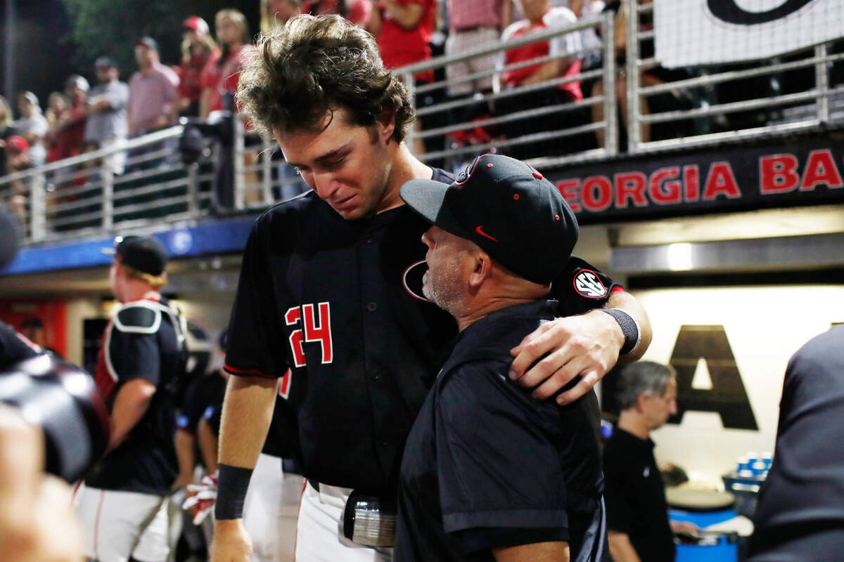 Georgia coach Wes Johnson consoles Georgia’s Charlie Condon (24) after losing Game 3 of the Super NCAA Regional against NC State at Foley Field on Monday, June 10, 2024 in Athens, Ga. NC State won 8-5.
