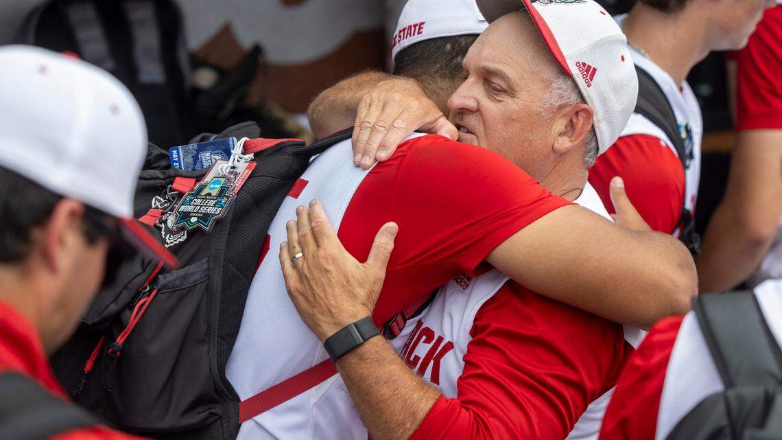 N.C. State coach Elliott Avent embraces pitcher Derrick Smith (25) following the Wolfpack’s 5-4 season ending loss to Florida in game seven of the College World Series on Monday, June 17, 2024 at Charles Schwab Field in Omaha, Nebraska.