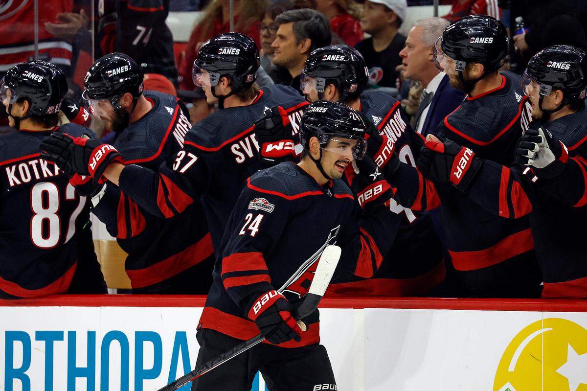 Carolina Hurricanes’ Seth Jarvis (24) celebrates along the bench after scoring a goal during the first period of an NHL hockey game against the Calgary Flames in Raleigh, N.C., Saturday, Nov. 26, 2022. (AP Photo/Karl B DeBlaker)