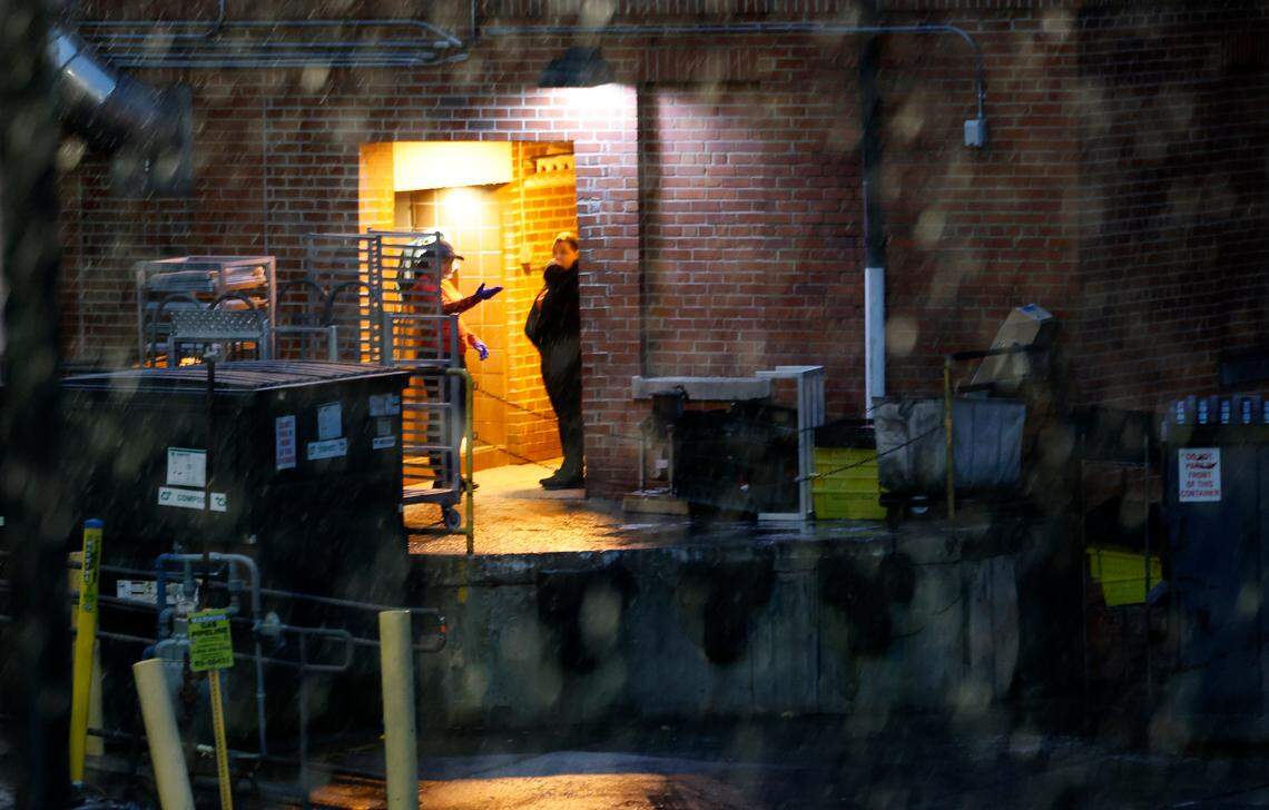 People at Clark Dining Hall check out the snow on the campus of N.C. State in Raleigh, N.C., Friday, Jan. 10, 2025.