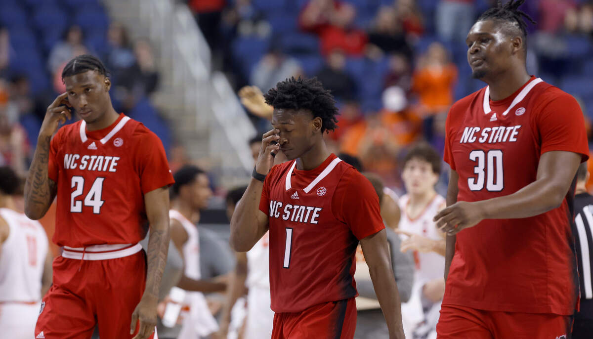 N.C. State’s Ernest Ross (24), Jarkel Joiner (1) and D.J. Burns Jr. (30) walk back to the bench after a timeout is called during the second half of Clemson’s 80-54 victory over N.C. State in the quarterfinals of the ACC Men’s Basketball Tournament in Greensboro, N.C., Thursday, March 9, 2023.