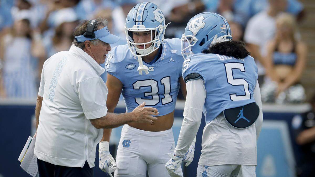 North Carolina head coach Bill Belichick talks to Will Hardy (31) and Gavin Gibson (5) during the first half of UNC’s game against Richmond at Kenan Stadium in Chapel Hill, N.C., Saturday, Sept. 13, 2025.