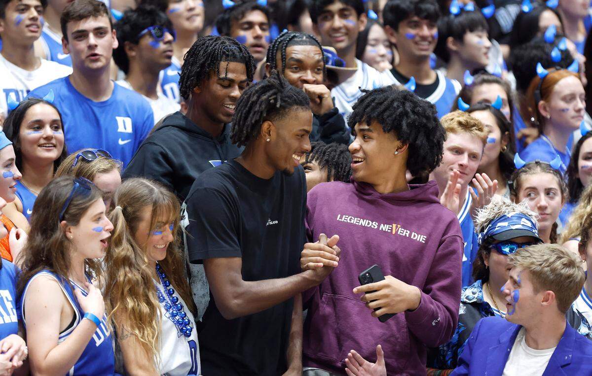 Duke basketball commit Mackenzie Mgbako, bottom left, greets recruit Dylan Harper, bottom right, as they stand with basketball commits Sean Stewart, top left, and Caleb Foster, top right, during Duke’s Countdown to Craziness at Cameron Indoor Stadium in Durham, N.C., Friday, Oct. 21, 2022.