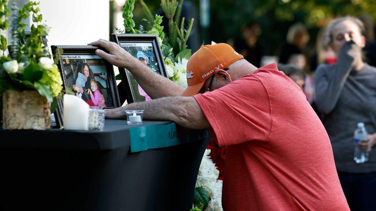 Mourners grieve at a memorial after a candlelight vigil Saturday, Oct.15, 2022, for those killed and wounded in a mass shooting in the Hedingham neighborhood in Raleigh, N.C., on Thursday.