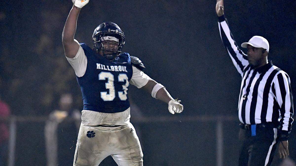 Millbrook defensive lineman Markez Wilbert (33) reacts after his sacking of Jordan quarterback Landon Melton (2) during the second half. The Millbrook Wildcats and the Jordan Falcons met in the third round of the NCHSAA 8A football playoffs in Raleigh, N.C. on November 21, 2025. 