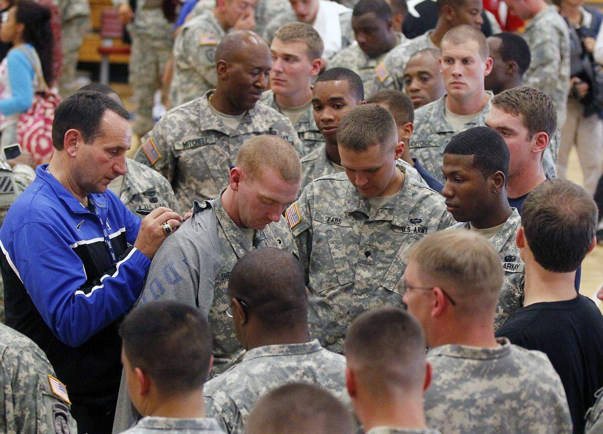 Duke head basketball coach Mike Krzyzewski draws a crowd as he signs autographs for members of the U.S. Army at Funk Gym on base at Fort Bragg in Fayetteville, N.C. Monday Oct. 15, 2011. The Blue Devils had just finished entertaining the soldiers with a 90 minute practice session.