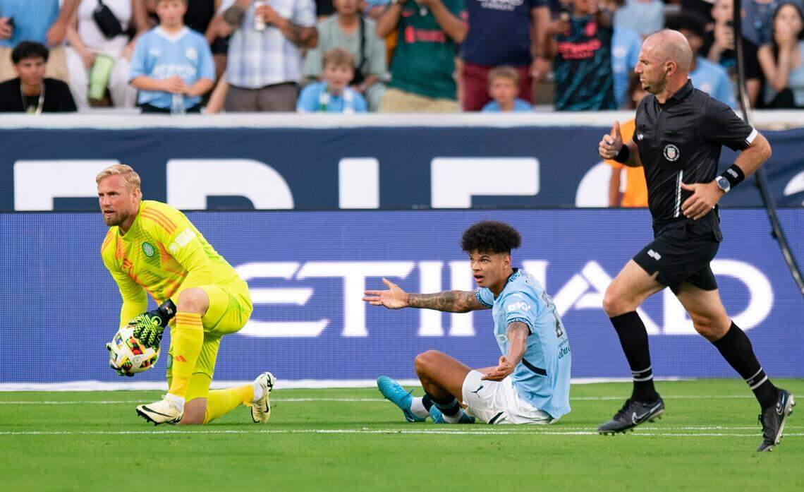 Celtic FC goalkeeper Kasper Schmeichel (1) looks to pass the ball as Manchester City midfielder Nico O’Reilly (75) reacts in frustration during the Celtic FC vs Manchester City at Kenan Stadium in Chapel Hill on Tuesday, July 23, 2024. Celtic FC won 4-3.