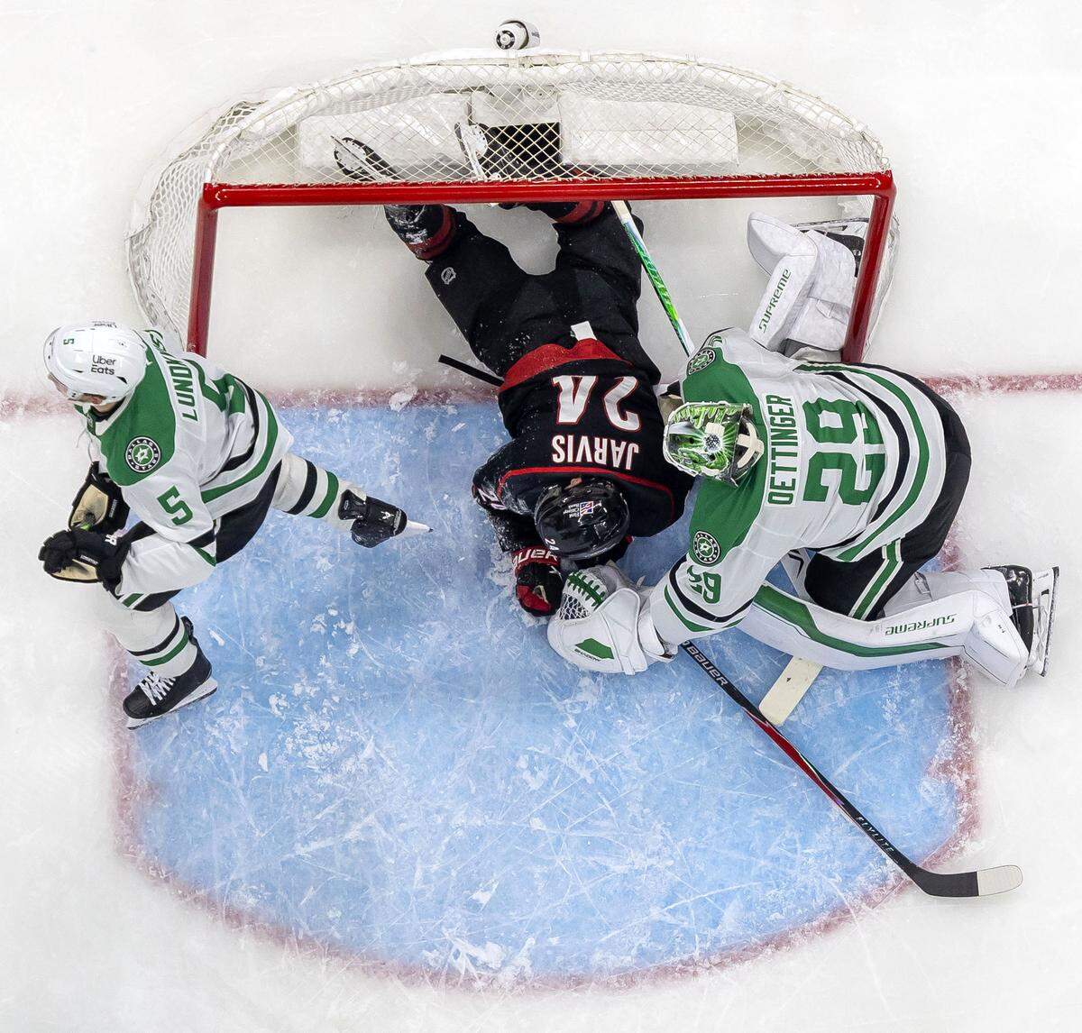 Carolina Hurricanes center Seth Jarvis (24) crashes into the Dallas net and goalie Jake Oettinger (29) in the second period on Tuesday, January 6, 2026 at Lenovo Center in Raleigh, N.C. 