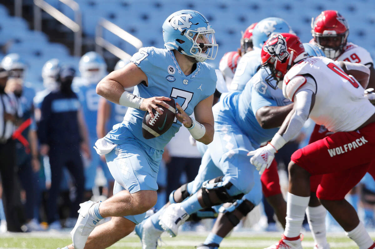 North Carolina quarterback Sam Howell (7) looks for receivers downfield during the first half of N.C. State’s game against UNC at Kenan Stadium in Chapel Hill, N.C., Saturday, Oct. 24, 2020.