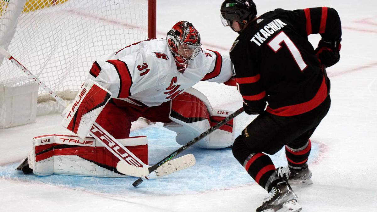 Carolina Hurricanes goaltender Frederik Andersen stops Ottawa Senators left wing Brady Tkachuk as he tries to score during the shootout in an NHL hockey game, Thursday, Jan. 27, 2022 in Ottawa, Ontario. (Adrian Wyld/The Canadian Press via AP)