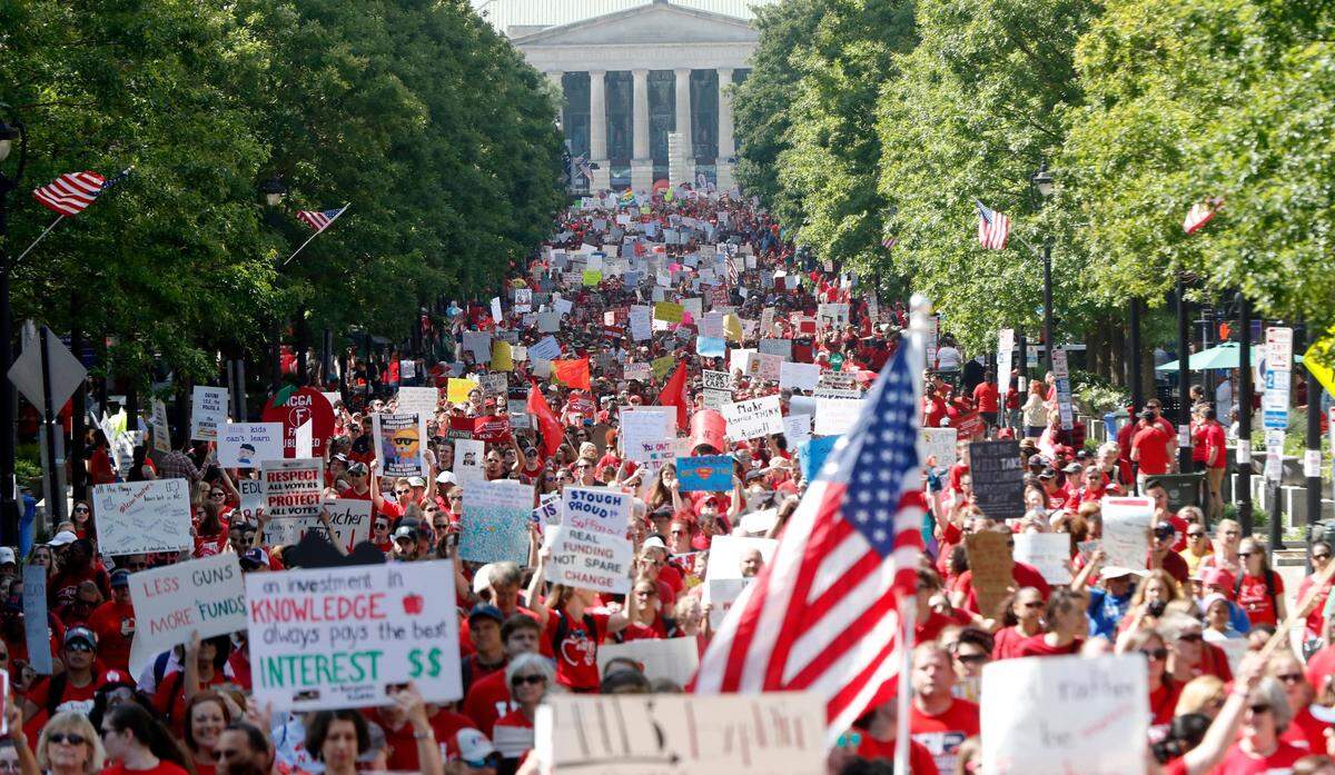 Thousands of teachers, other school employees and their supporters marched up Fayetteville Street through downtown Raleigh during a “Day of Action” organized by the N.C. Association of Educators  on May 1, 2019. Wake County has cancelled all in-person classes on Friday ahead of this year’s protest.