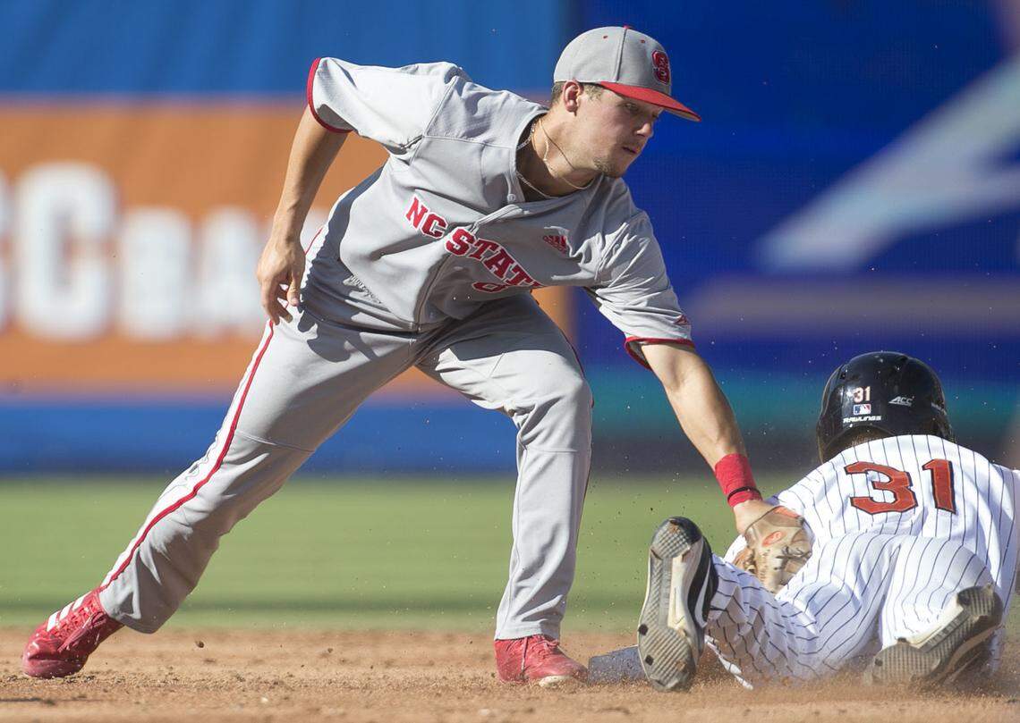 Virginia’s Jake McCarthy (31) slides safely into second base beating the tag by North Carolina State shortstop Will Wilson (8) during the 2018 Atlantic Coast Conference baseball tournament at Durham Bulls Athletic Park in Durham, N.C.
