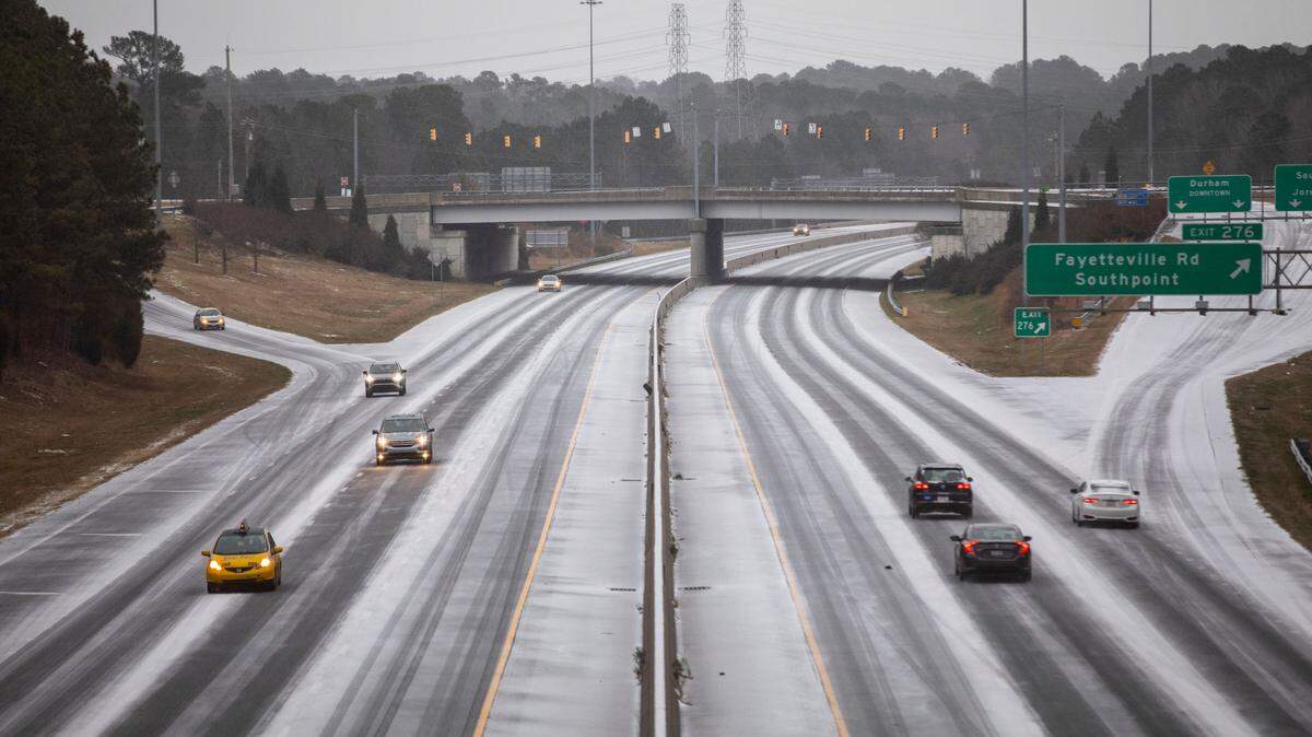 Cars travel along I-40 near Southpoint Mall in Durham, North Carolina, on Sunday, Jan. 16. Parts of North Carolina are expected to get additional snow and ice accumulations Sunday.
