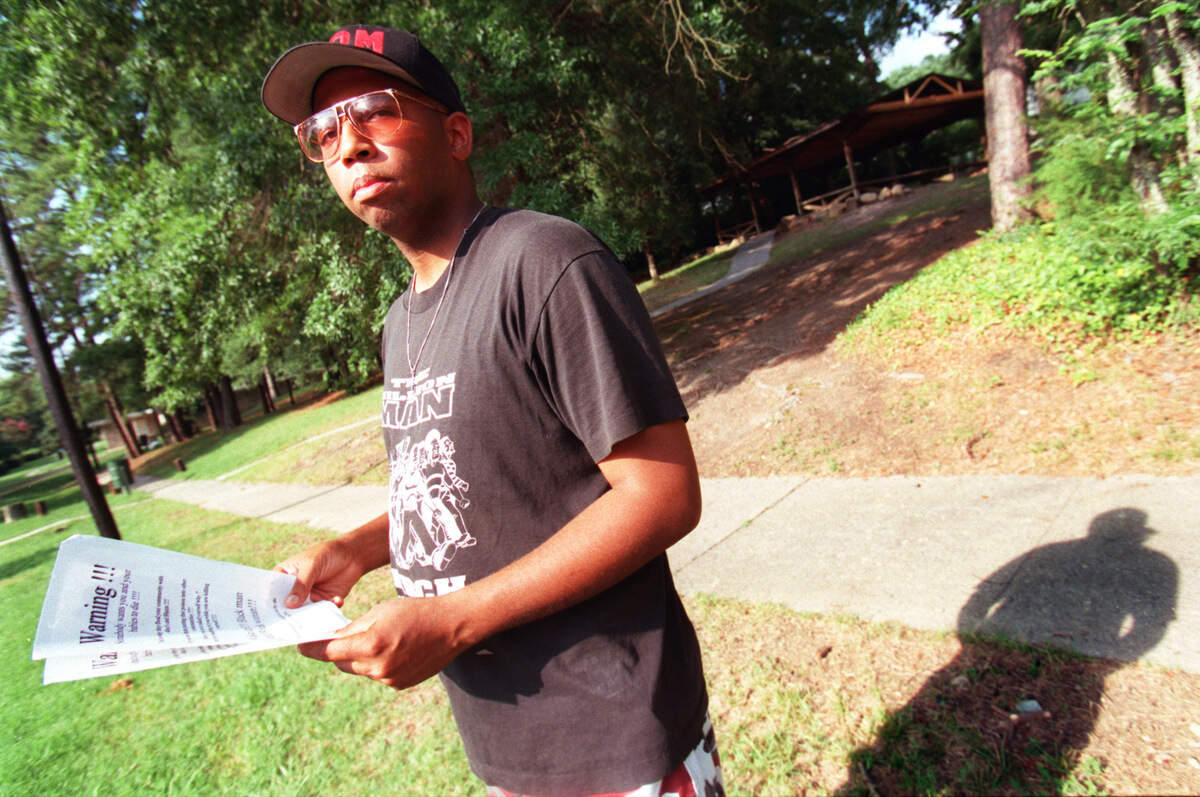 Paul Scott holds flyers warning against malt liquor in this 1999 file photo.