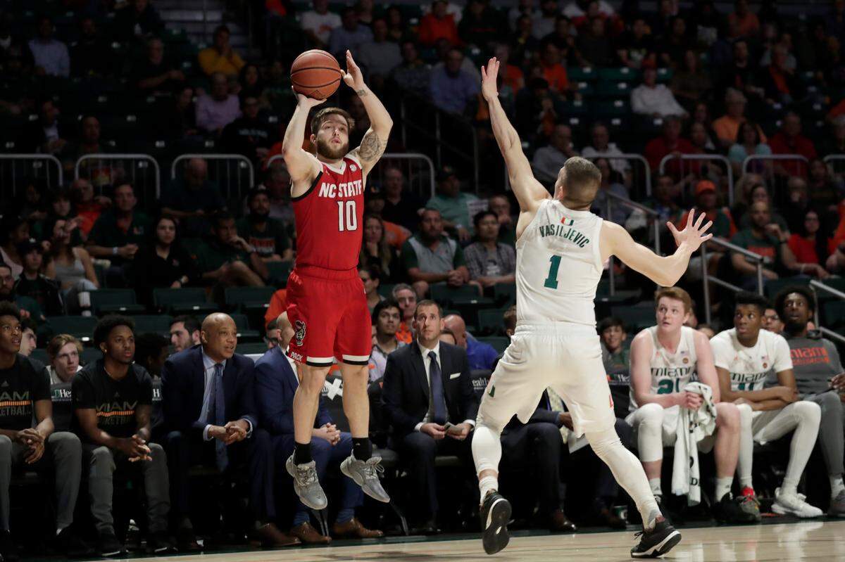 North Carolina State guard Braxton Beverly (10) shoots over Miami guard Dejan Vasiljevic (1) during the first half of an NCAA college basketball game, Wednesday, Feb. 5, 2020, in Coral Gables, Fla. Northe Carolina State won 83-72.