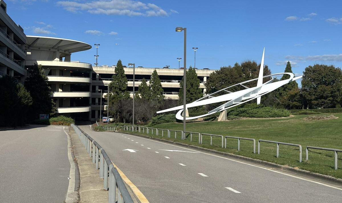 The Triangle Icon sculpture seen at ground level at the entrance to the parking deck at Raleigh-Durham International Airport. The airport may move the steel monument honoring the Wright Brothers to a more prominent location.