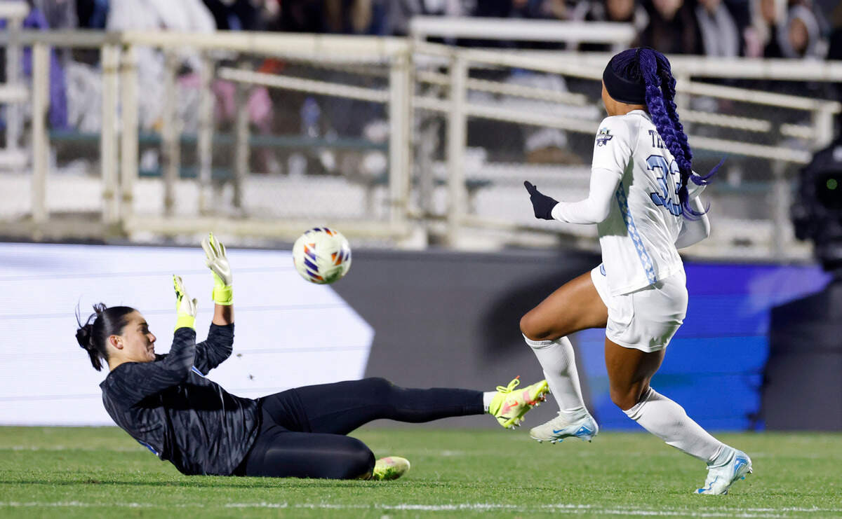 North Carolina’s Olivia Thomas (33) kicks the ball past Duke goalie Leah Freeman (0) to score during the first half of UNC’s game against Duke in the semifinals of the 2024 Women’s College Cup at WakeMed Soccer Park in Cary, N.C., Friday, Dec. 6, 2024.