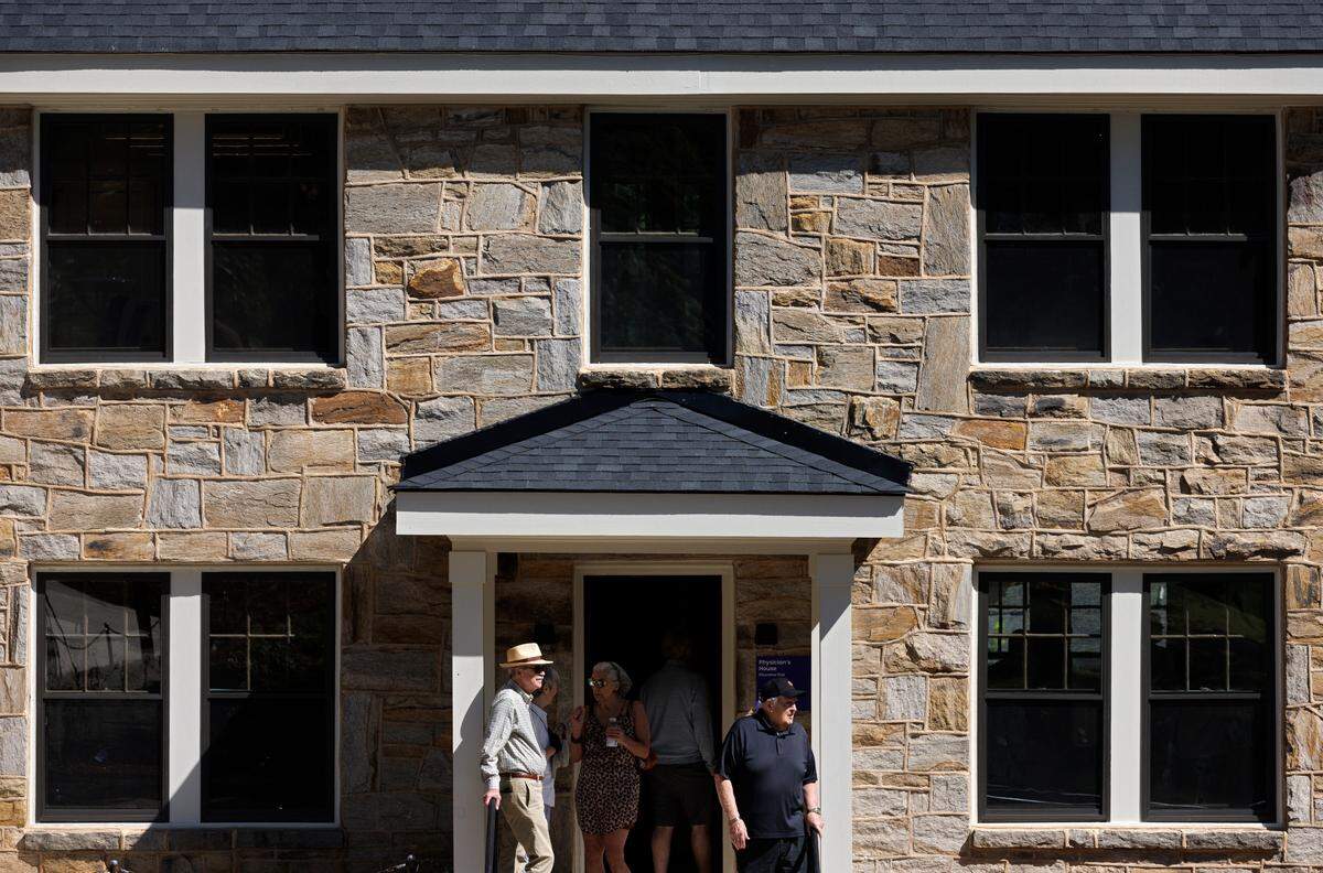 People tour a recently renovated historic home at Dorothea Dix Park on Friday, May 31, 2024, in Raleigh, N.C. The house is one of three homes built in 1923 in a post World War I expansion of the hospital.