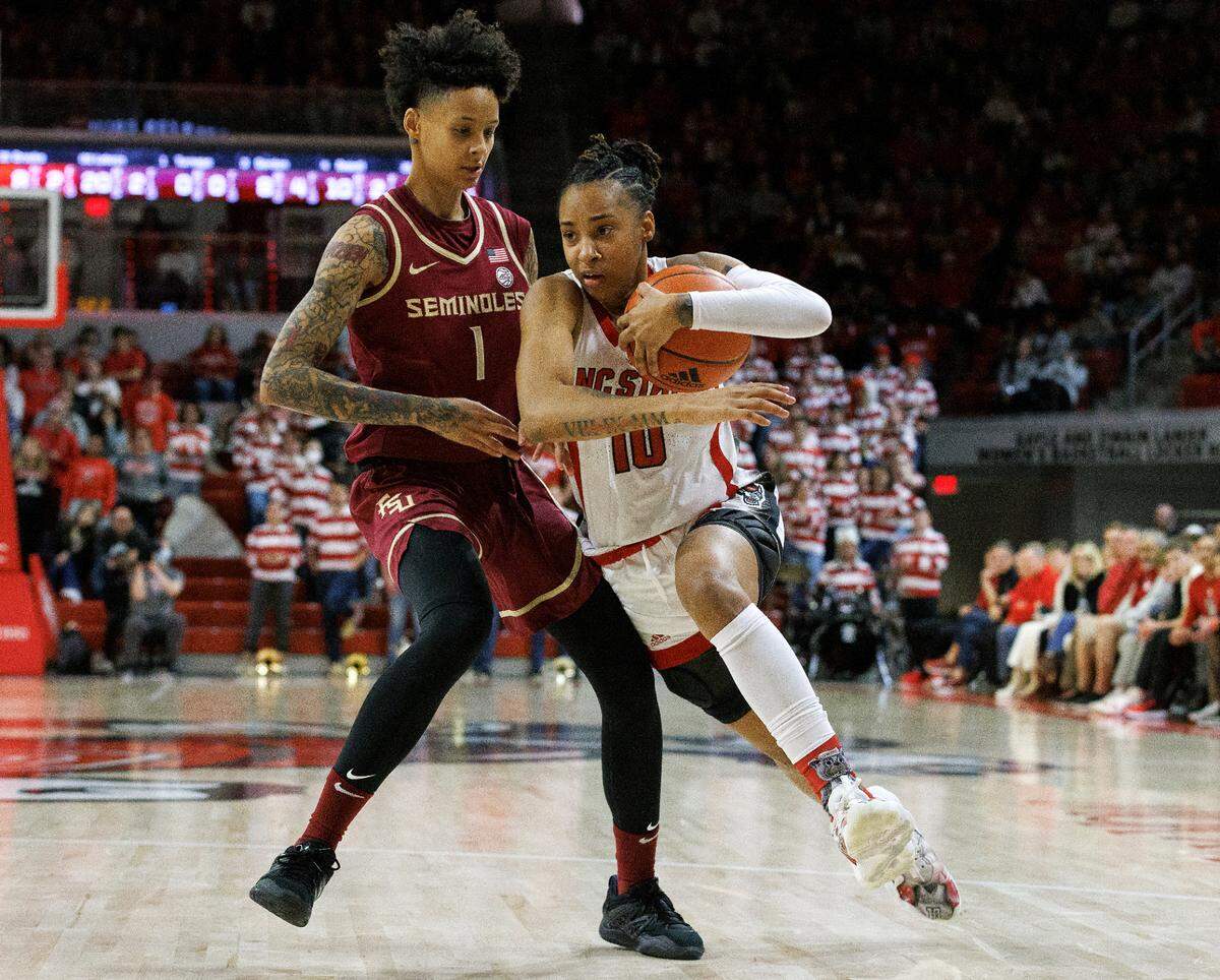 N.C. State’s Aziaha James drives past Florida State’s Brianna Turnage during the second half of the Wolfpack’s 88-80 win on Thursday, Jan. 4, 2023, at Reynolds Coliseum in Raleigh, N.C.