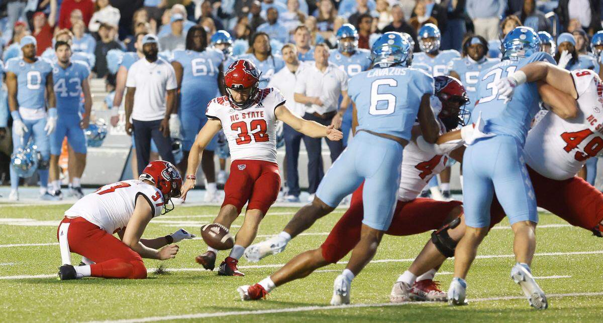 N.C. State’s Christopher Dunn (32) kicks a 29-yard field goal at the end of the first half of N.C. State’s game against UNC at Kenan Stadium in Chapel Hill, N.C., Friday, Nov. 25, 2022.