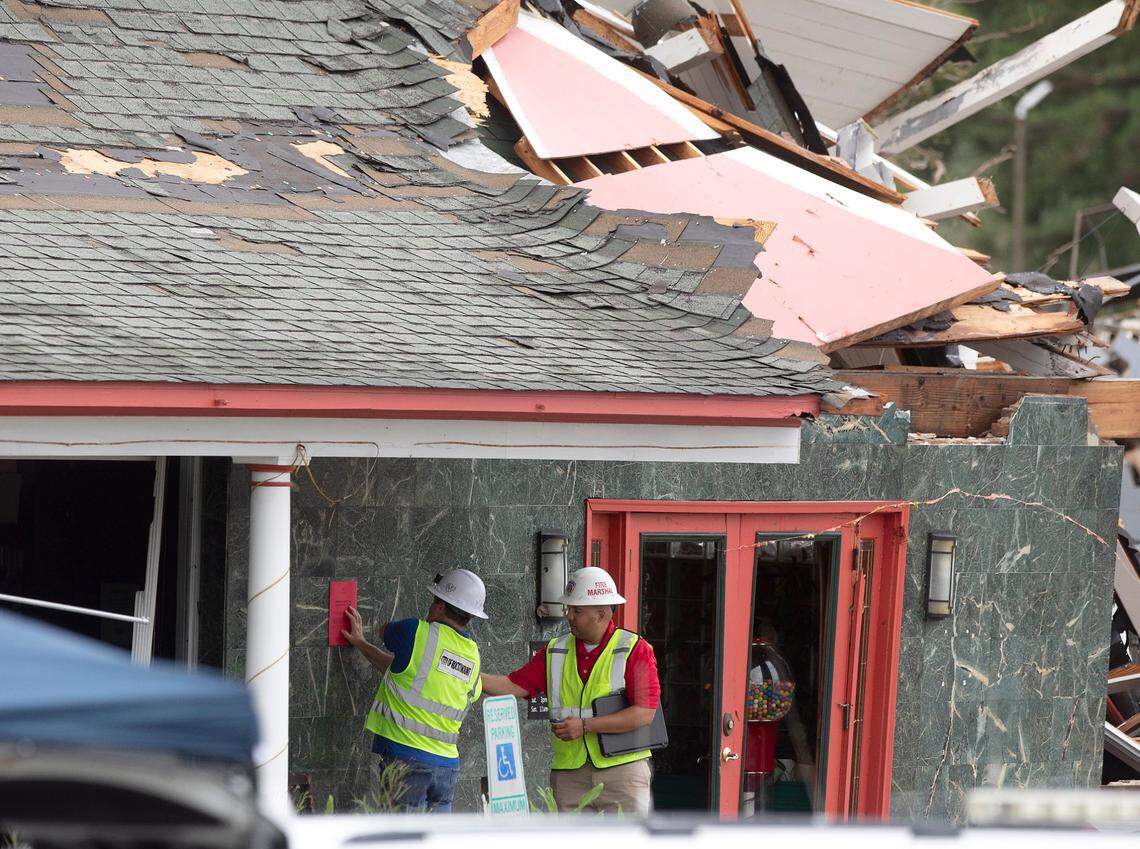 Officials work outside of Hing Ta Restaurant after the building sustained damage during a tornado in Rocky Mount, N.C. on Friday, Sept. 27, 2024.