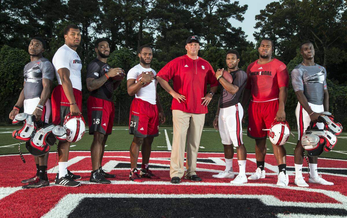 N.C. State coach Dave Doeren poses with players he recruited before the start of the 2016 season, from left, Shawn Boone, Bradley Chubb, Jaylen Samuels, Matt Dayes, Nyheim Hines, B.J. Hill and Jack Tocho.