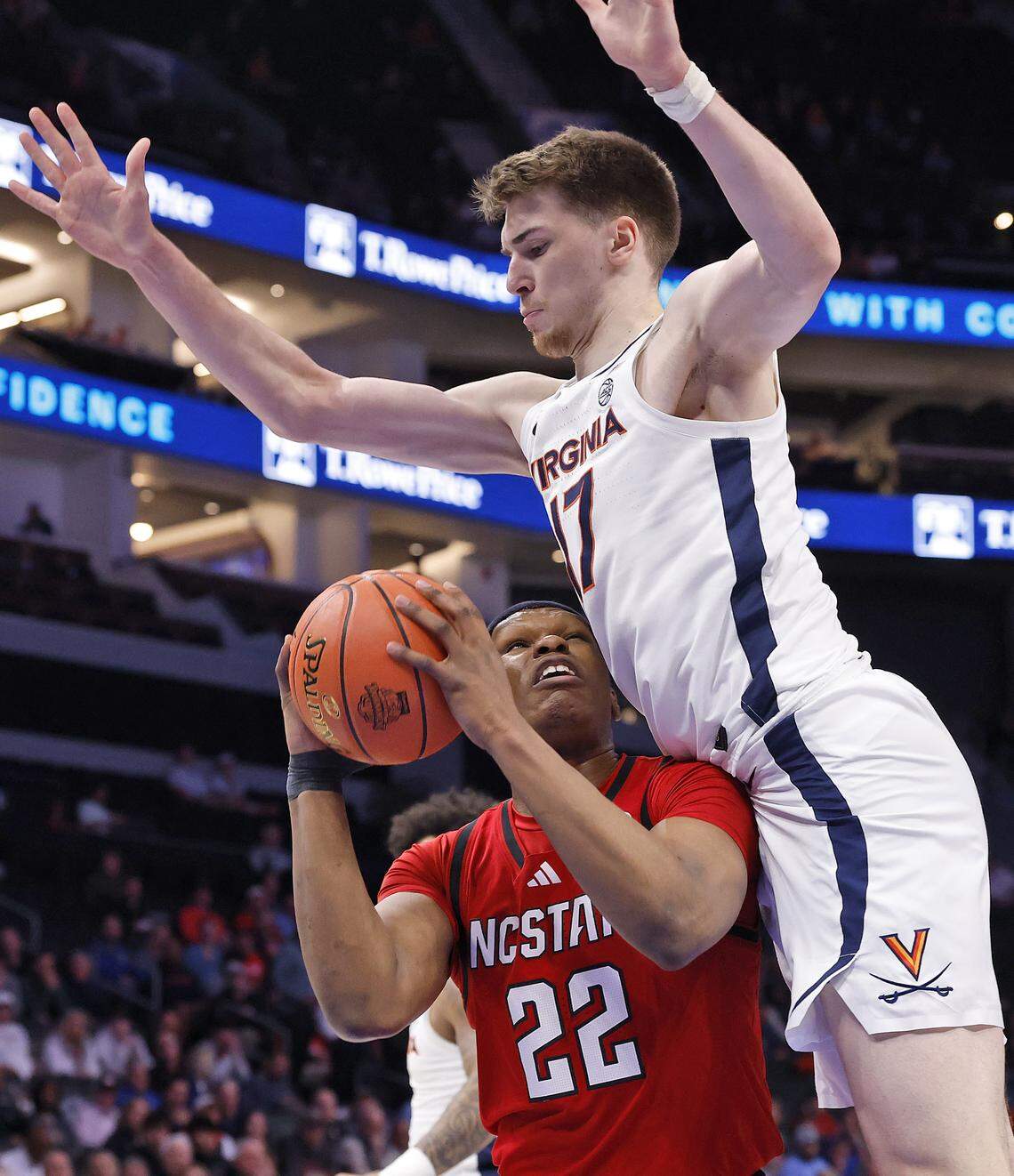 N.C. State's Ven-Allen Lubin is fouled by Virginia's Johann Grünloh during the first half of the Wolfpack’s 81-74 loss in the ACC Tournament quarterfinals on Thursday, March 12, 2026, at the Spectrum Center in Charlotte, N.C. 