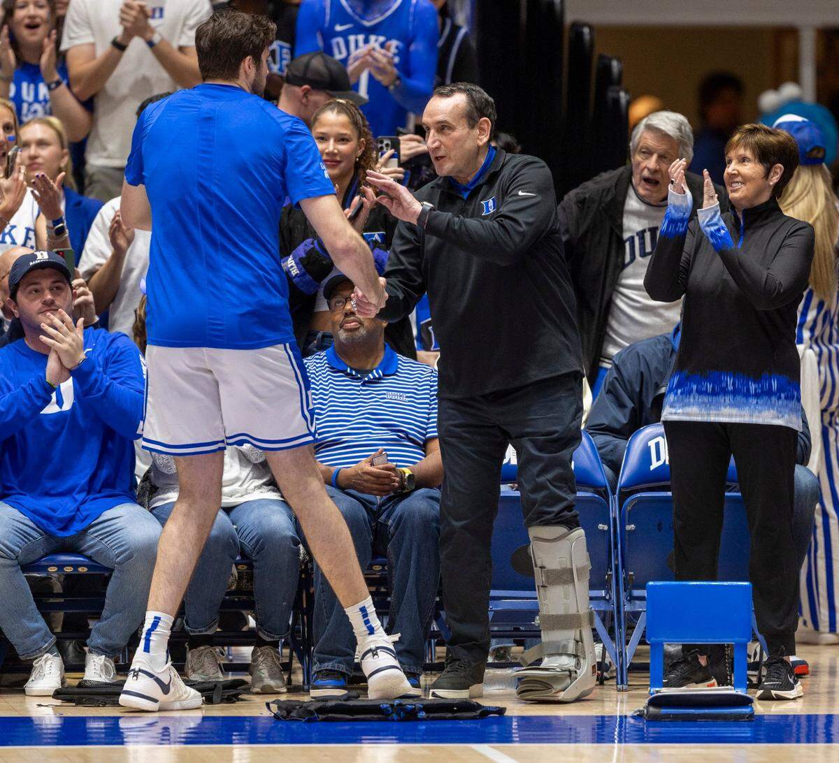 Former Duke coach Mike Krzyzewski congratulates senior Ryan Young (15) as he is recognized prior to the Blue Devils’ game against North Carolina on Saturday, March 9, 2024 at Cameron Indoor Stadium in Durham, N.C.