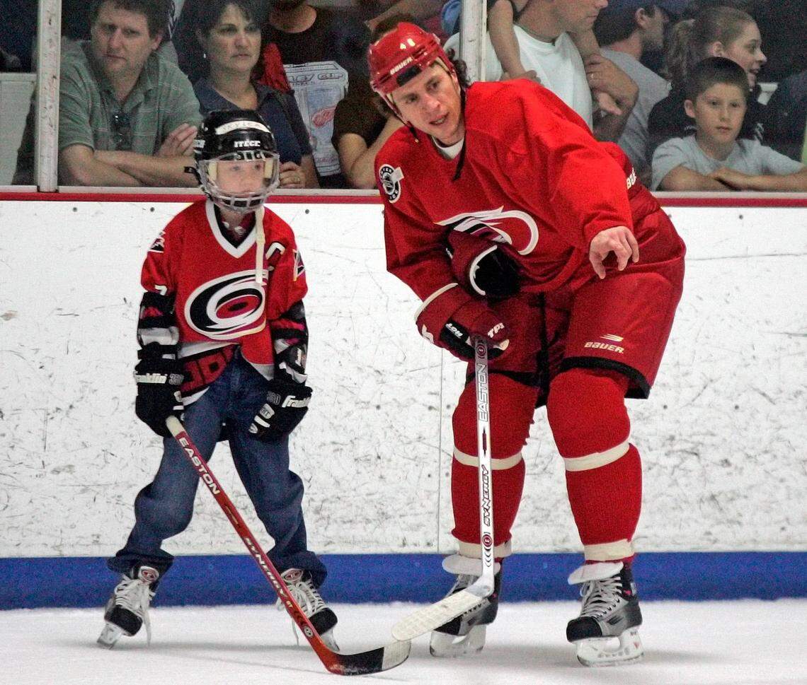 Carolina Hurricanes’ Rod Brind ‘Amour instructs his son Skyler (6) following the teams practice, Saturday, June 3, 2006, in Raleigh, N.C.