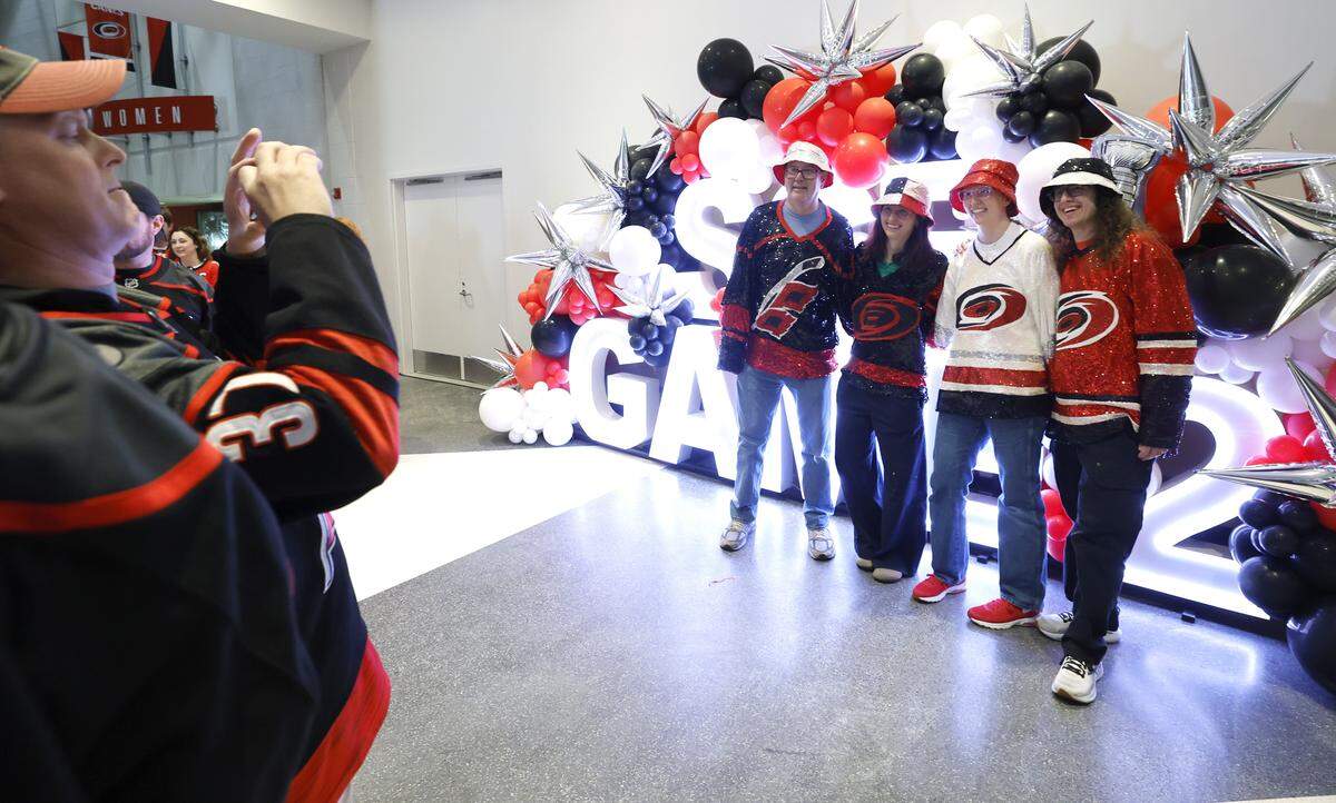 From left, Earl Saito and his daughters Shelly and Allison along with Allison’s boyfriend Nic Garcia pose in concourse of the Lenovo Center before the Hurricanes’ game against the Golden Knights in the second game of the Stanley Cup Final at the Lenovo Center in Raleigh, N.C., Thursday, June 4, 2026.